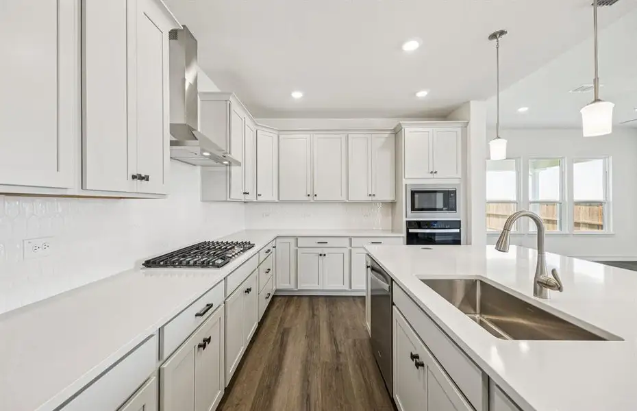 High-end gourmet kitchen with premium finishes and upgraded appliances *Real home pictured High-end gourmet kitchen with premium finishes and upgraded appliances *Real home pictured