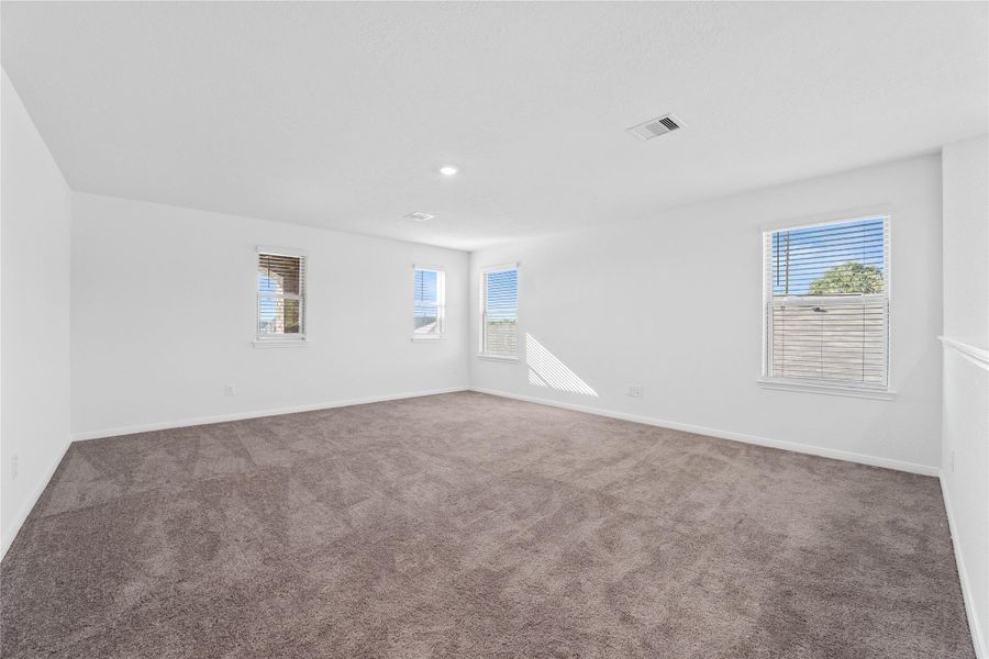 This spacious game room is the ultimate destination for fun. With plenty of room a friendly competition around the pool table to movie marathons, this incredible game room is where unforgettable memories are made. Featuring plush carpet flooring, plenty of windows for natural lighting, neutral toned walls, and recessed lighting. This spacious game room is the ultimate destination for fun. With plenty of room a friendly competition around the pool table to movie marathons, this incredible game room is where unforgettable memories are made. Featuring plush carpet flooring, plenty of windows for natural lighting, neutral toned walls, and recessed lighting.