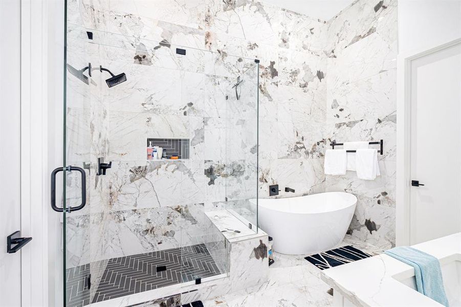 Bathroom featuring tile walls and independent shower and bath