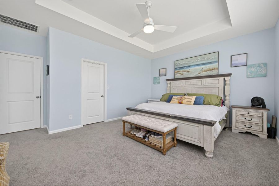 Bright primary bedroom with generous space, multiple windows and an ensuite bathroom