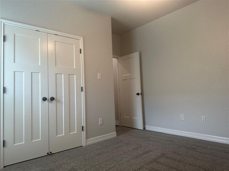 Unfurnished bedroom with carpet floors and a closet