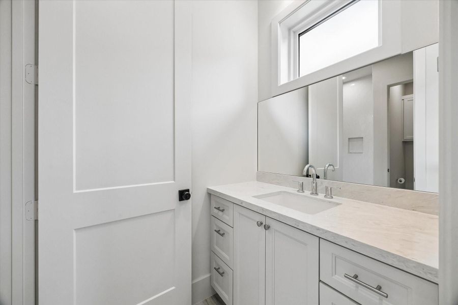 The Jack-and-Jill bath connects bedrooms 2 and 3, offering a functional layout with updated finishes and convenient shared access. The Jack-and-Jill bath connects bedrooms 2 and 3, offering a functional layout with updated finishes and convenient shared access.