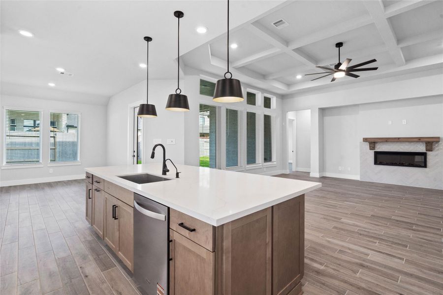 Anchored by the expansive kitchen island, this open-concept layout offers a commanding viewpoint into the family and dining rooms, ensuring seamless connection and effortless entertaining.