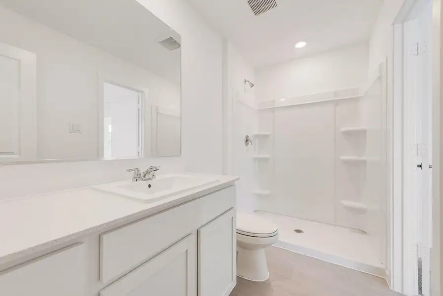 Full bathroom featuring light wood-style floors, a shower stall, vanity, and recessed lighting