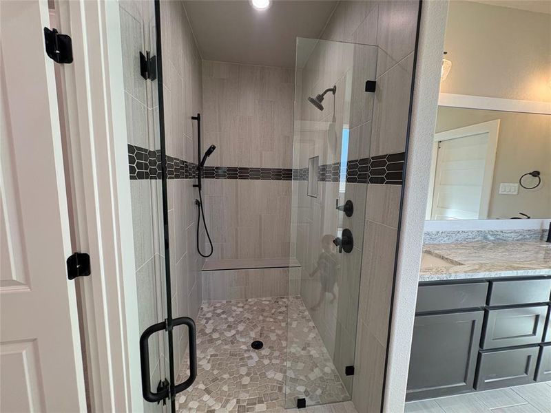 Bathroom featuring vanity and a stall shower
