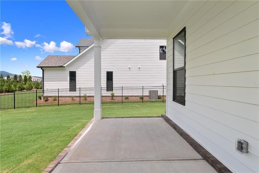 Exterior details and patio area of a home in Promenade at Sawnee Village, Cumming (Image 28).