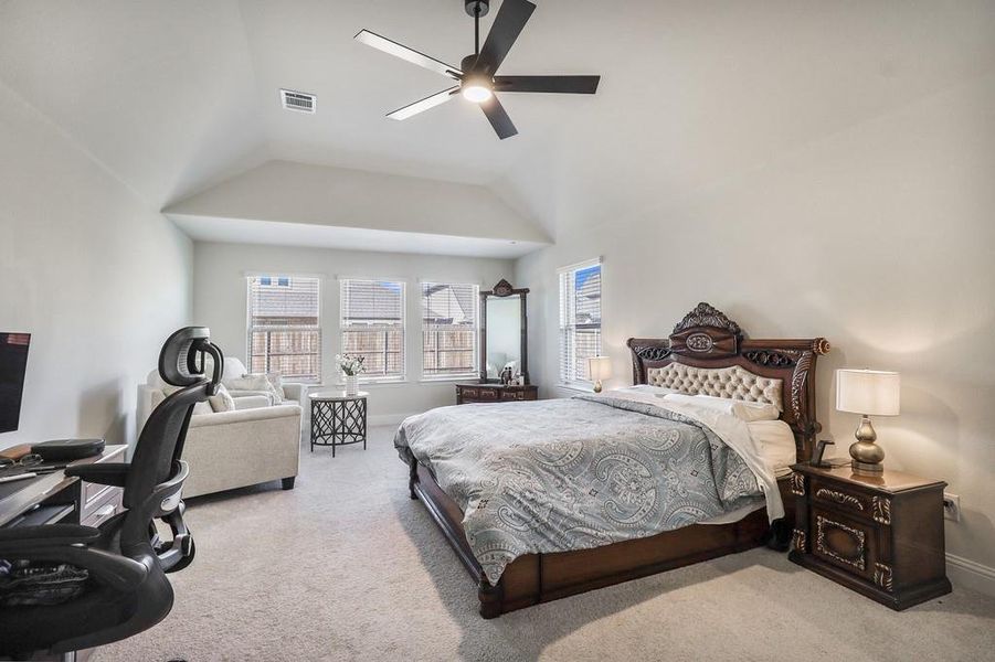 Bedroom featuring carpet flooring, a ceiling fan, and lofted ceiling