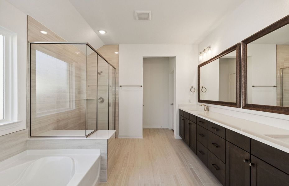 Spacious owner's bathroom with dual vanity and ove