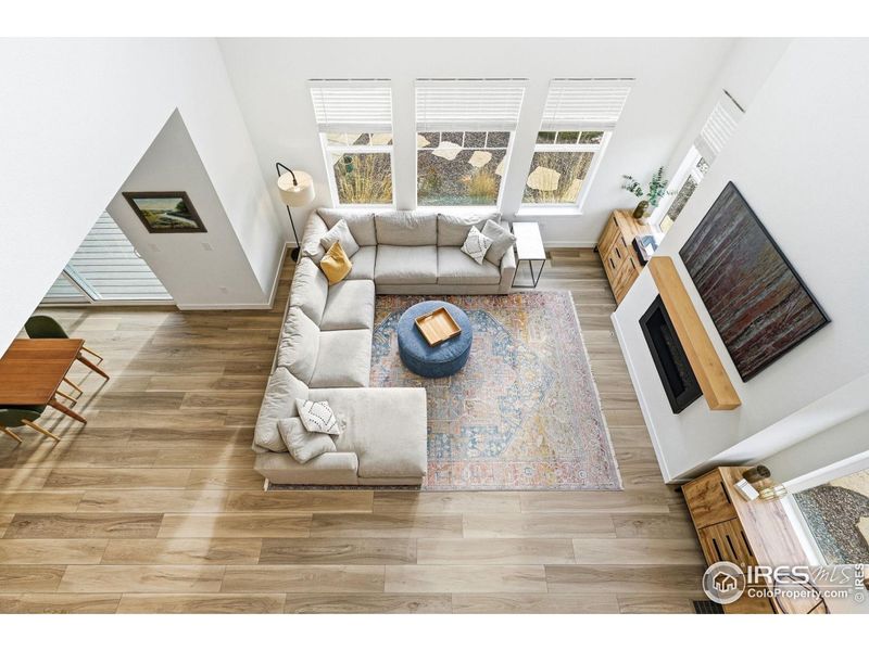 A wide-angle view of the main living space, showing the open flow, soaring ceilings, and natural light that define the heart of the home.