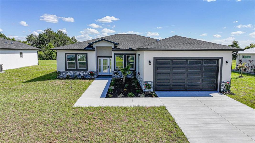 Front exterior of a new home in , Punta Gorda, FL, highlighting curb appeal (Image 24).