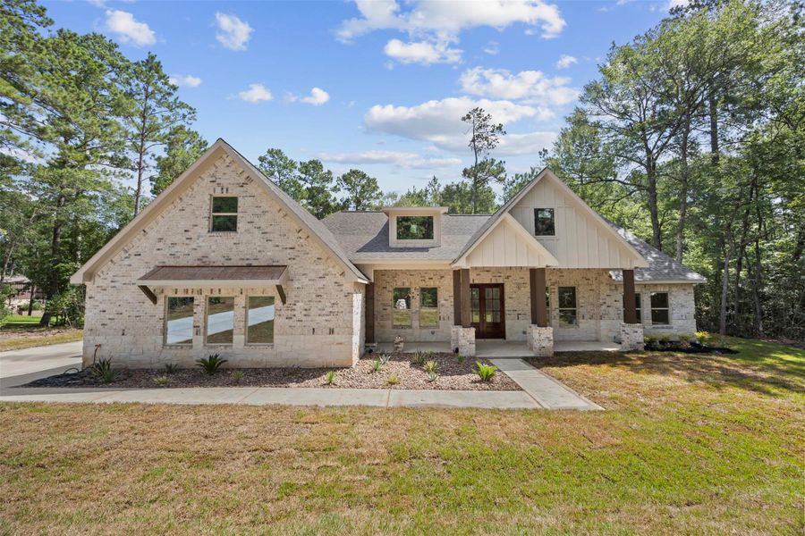 Front exterior of a new home in , New Waverly, TX, highlighting curb appeal (Image 1). Front exterior of a new home in , New Waverly, TX, highlighting curb appeal (Image 1).