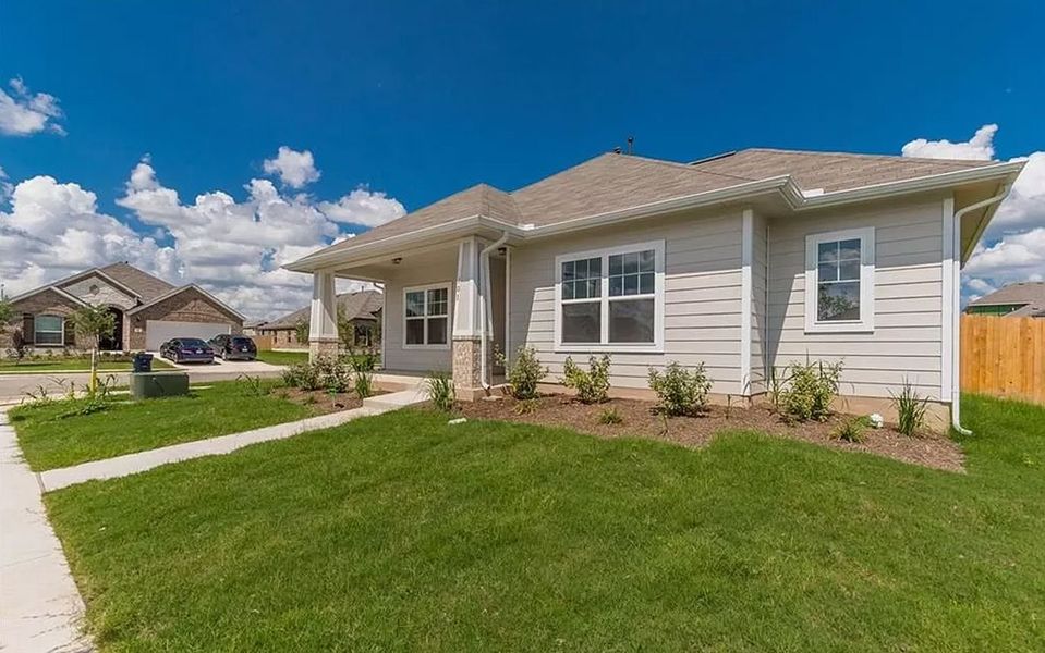 Front exterior of a new home in Brooklands, Hutto, TX, highlighting curb appeal (Image 19).