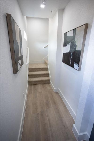 Corridor with hardwood / wood-style flooring