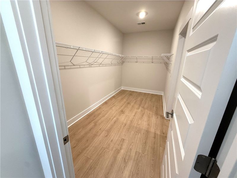 This spacious walk-in closet features convenient s