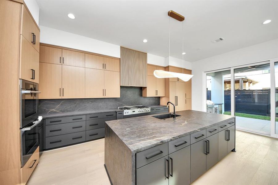 State-of-the-art kitchen with custom cabinetry featuring soft-closing drawers and spacious pots and pans storage.