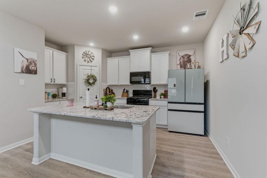 Kitchen with island and granite countertops