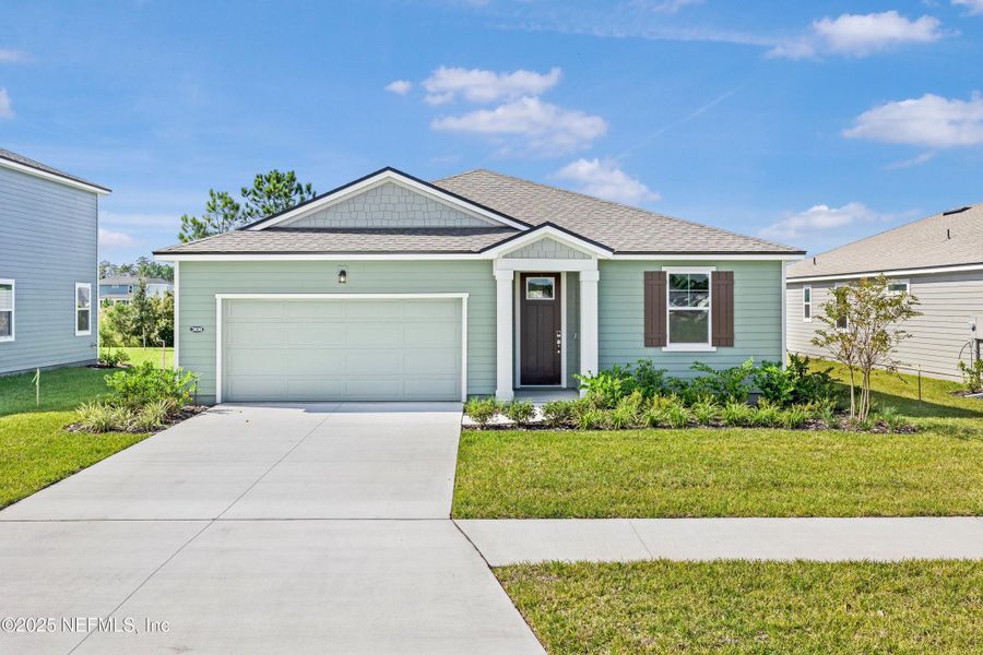 Front exterior of a new home in Lakes at Bella Lago, Green Cove Springs, FL, highlighting curb appeal (Image 1).