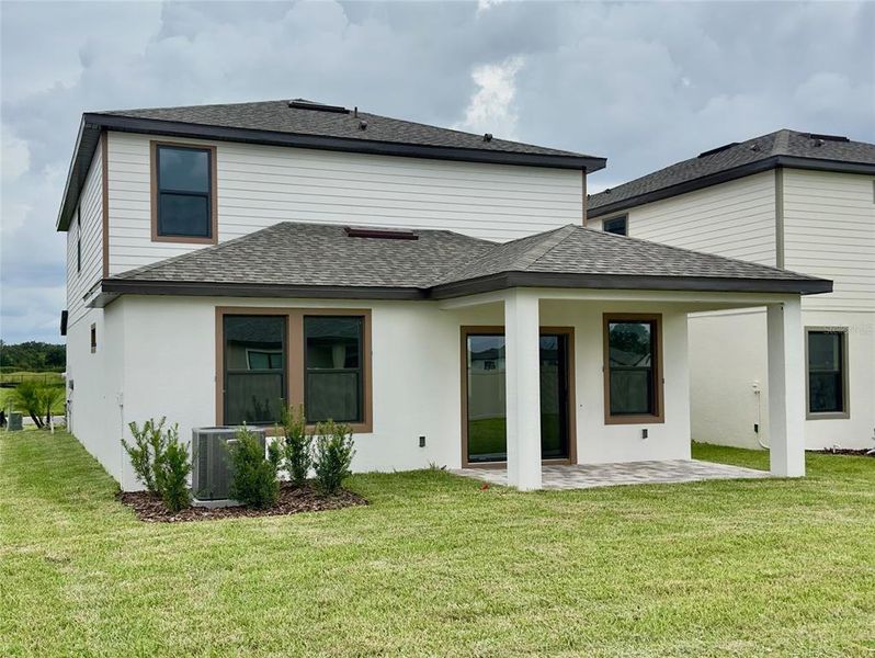 Front exterior of a new home in Grasslands West, Lakeland, FL, highlighting curb appeal (Image 23).