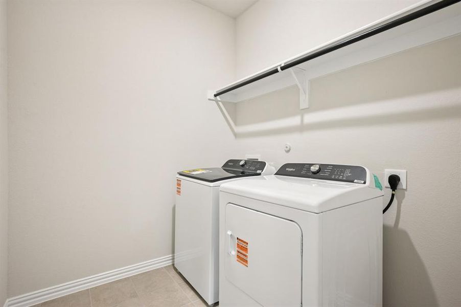 Laundry room with Whirlpool washer and dryer and light tile  floors.  Washer and Dryer Included!