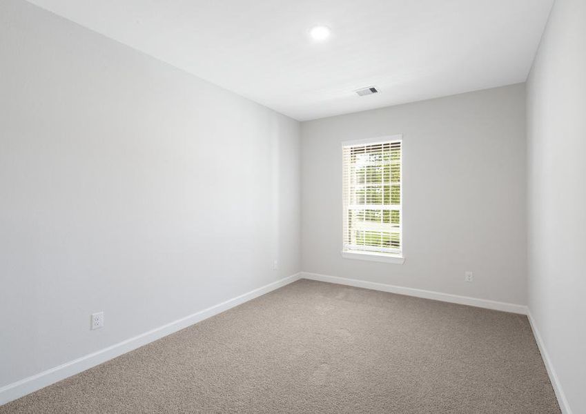 Secondary bedroom with carpet