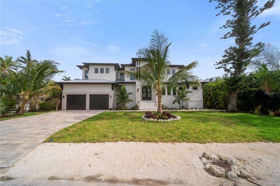 Front exterior of a new home in , Longboat Key, FL, highlighting curb appeal (Image 33). Front exterior of a new home in , Longboat Key, FL, highlighting curb appeal (Image 33).