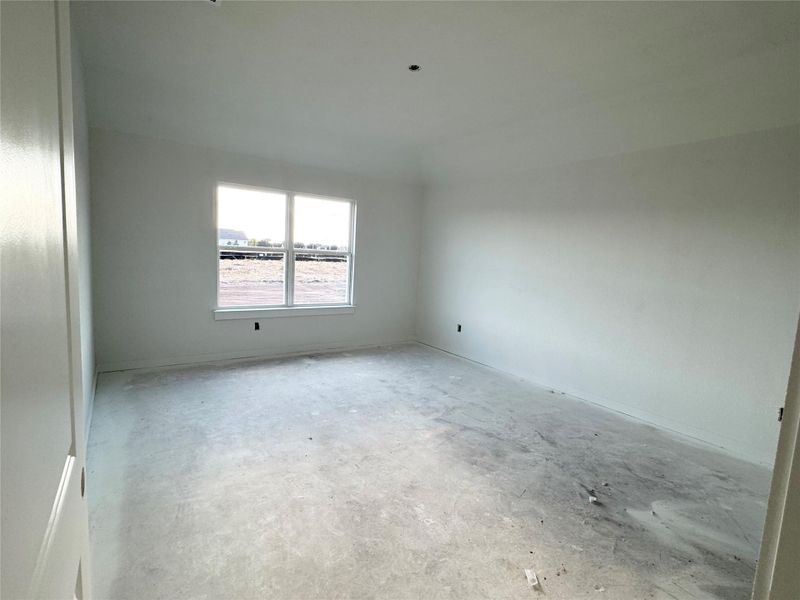 Spare room with unfinished concrete floors