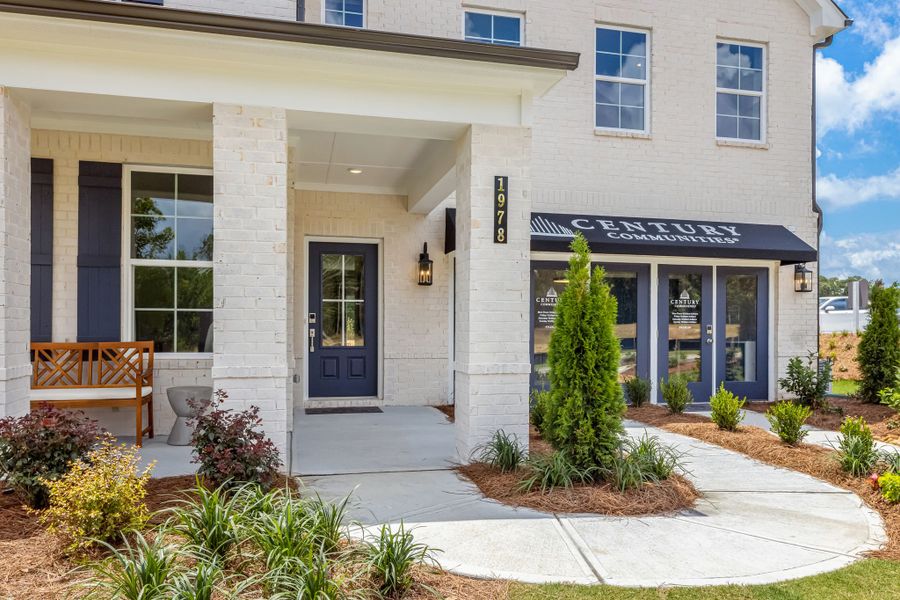 A building with a bench and a tree in front of it. A building with a bench and a tree in front of it.