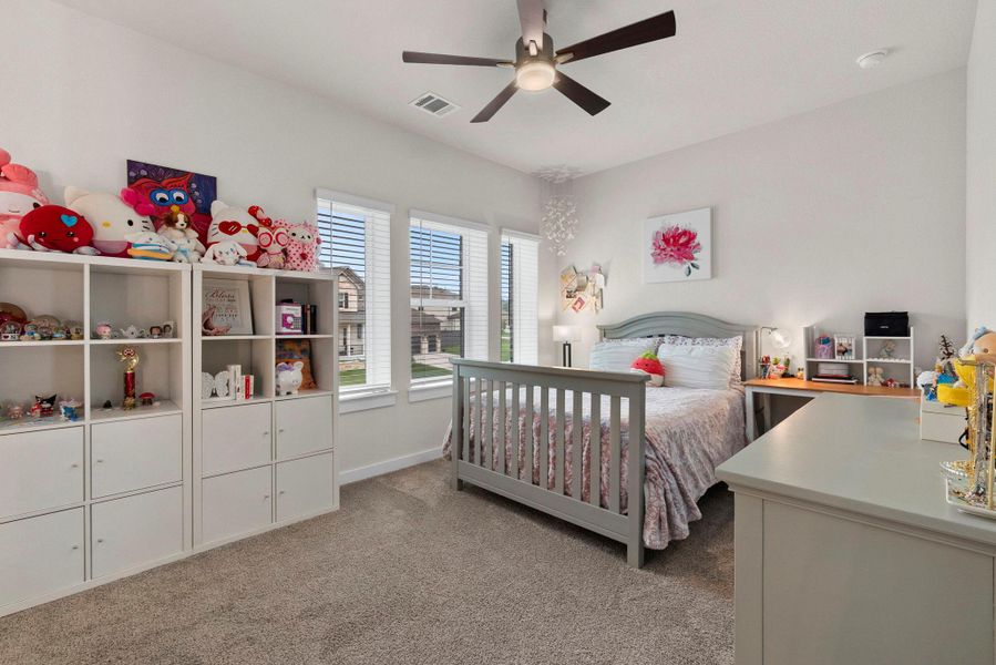 Spacious room featuring light gray carpeting and white walls