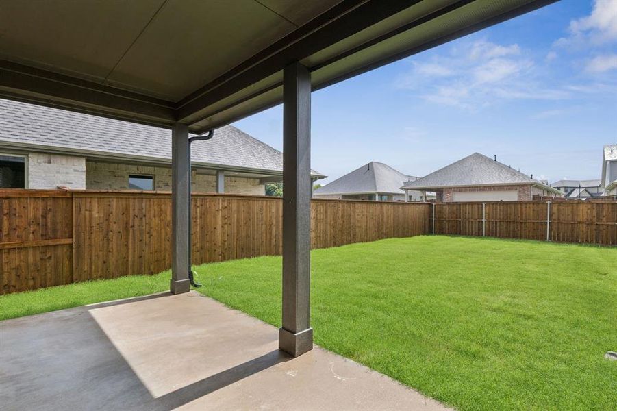 Fenced backyard featuring a patio area Fenced backyard featuring a patio area