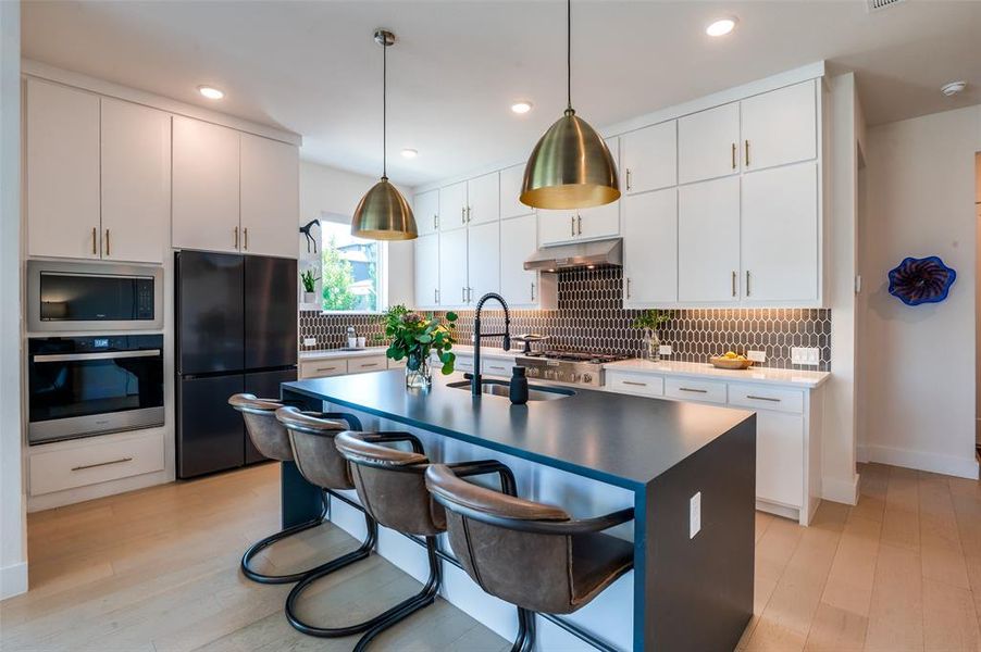 Chef's kitchen!  Island with quartz waterfall countertops.