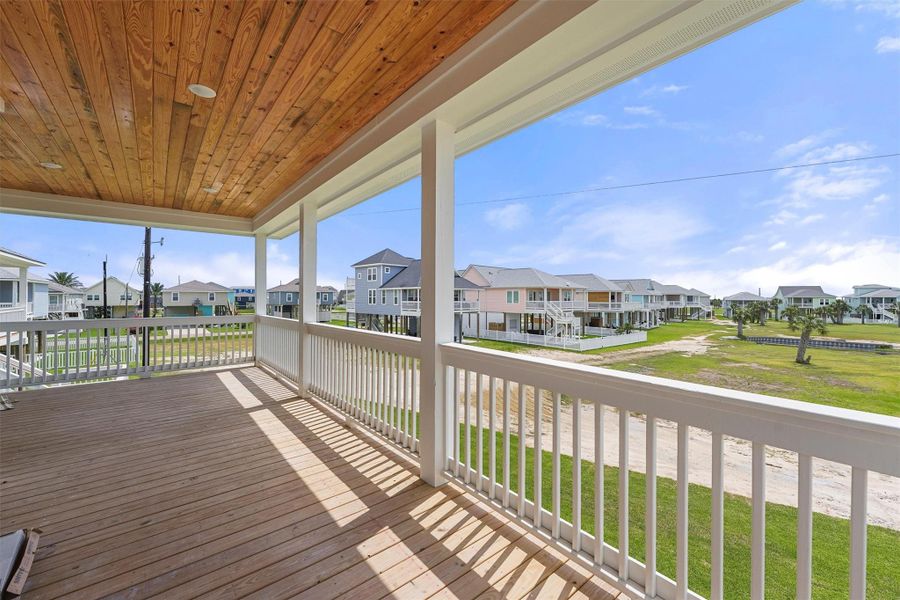 Take in coastal breezes and neighborhood pond views from the oversized covered balcony with a beautiful wood-paneled ceiling. Take in coastal breezes and neighborhood pond views from the oversized covered balcony with a beautiful wood-paneled ceiling.