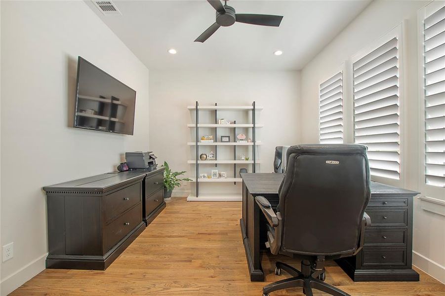 This downstairs bedroom is currently used as an office & noted as such.  There is a large walk in closet, plantation shutters & a ceiling fan.