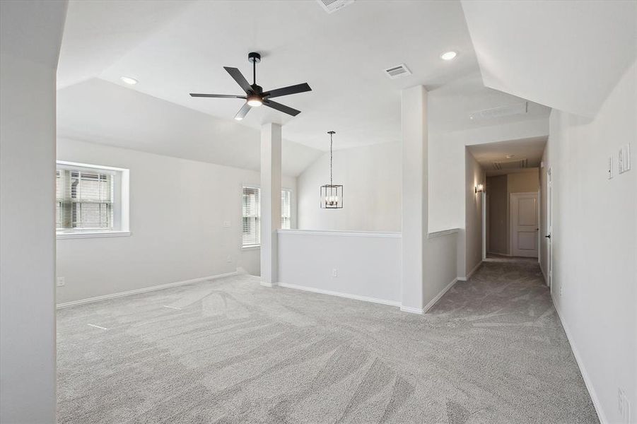 Carpeted empty room featuring vaulted ceiling, attic access, recessed lighting, baseboards, and ceiling fan