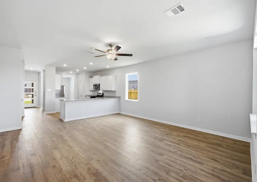 Open-concept family room with kitchen view in Montgomery floor plan