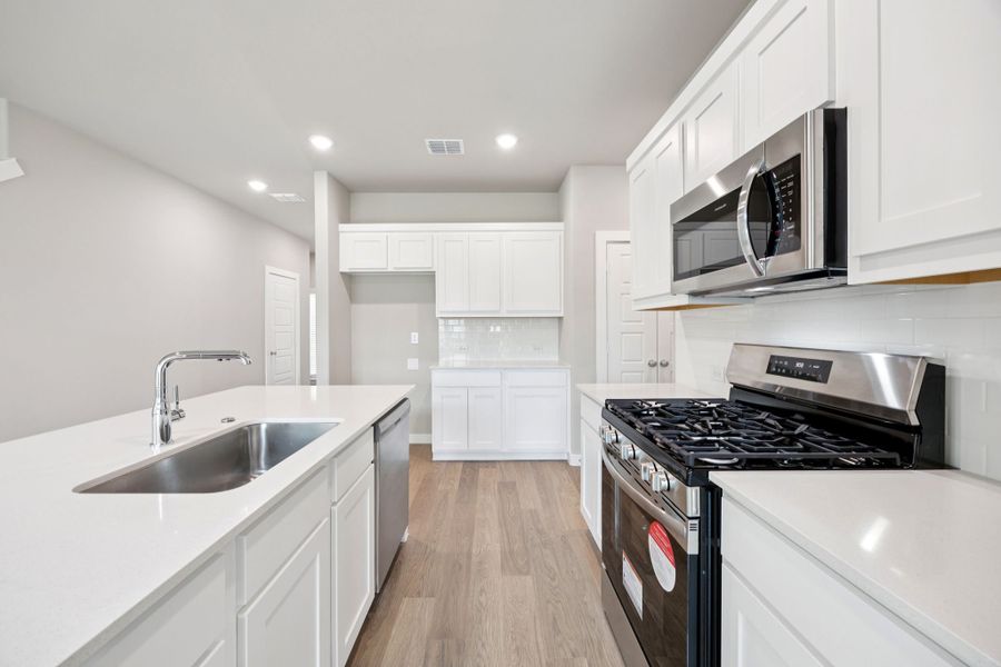 Kitchen in the Mesquite home plan by Trophy Signature Homes – REPRESENTATIVE PHOTO Kitchen in the Mesquite home plan by Trophy Signature Homes – REPRESENTATIVE PHOTO