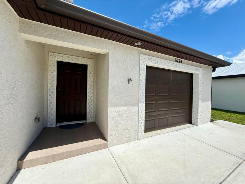 Front exterior of a new home in , Fort Pierce, FL, highlighting curb appeal (Image 24).