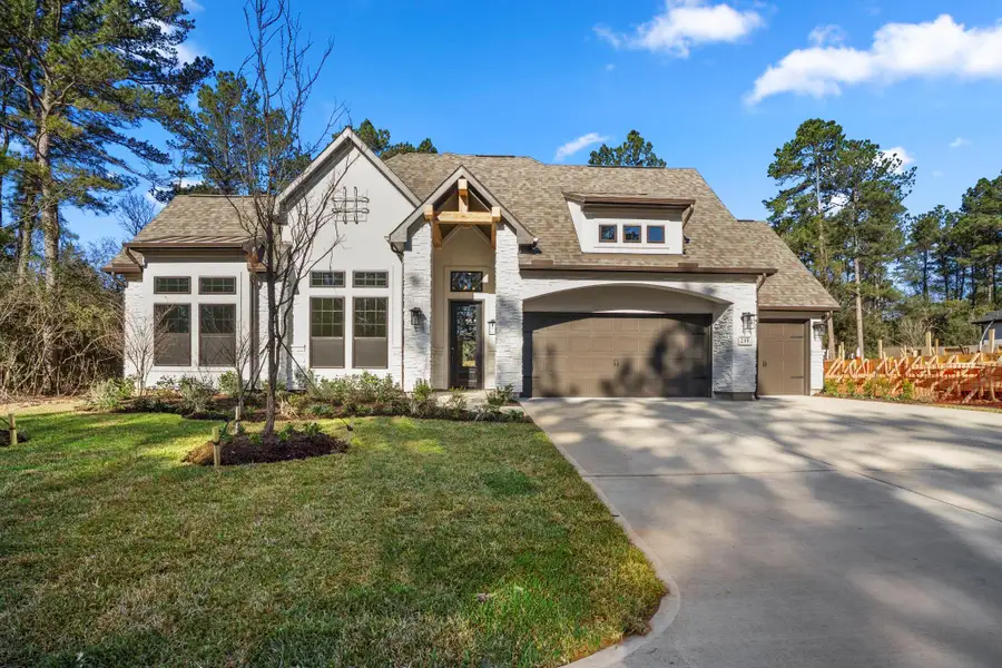 Front exterior of a new home in The Woodlands Hills, Willis, TX, highlighting curb appeal (Image 2).