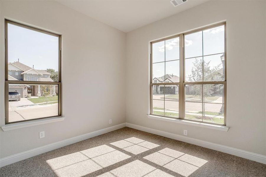 Carpeted spare room with a healthy amount of sunlight