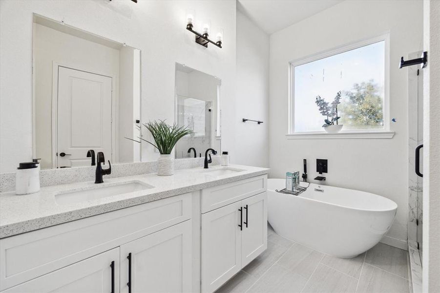 Spa-like primary bath with elegant freestanding tub & oversized shower to wash off the day.