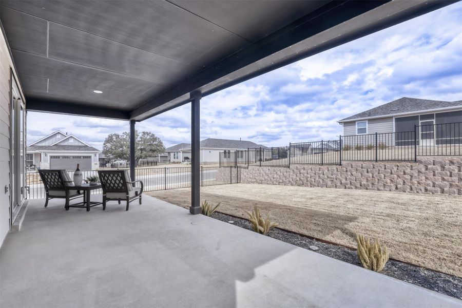 Fenced backyard featuring a patio and a residential view