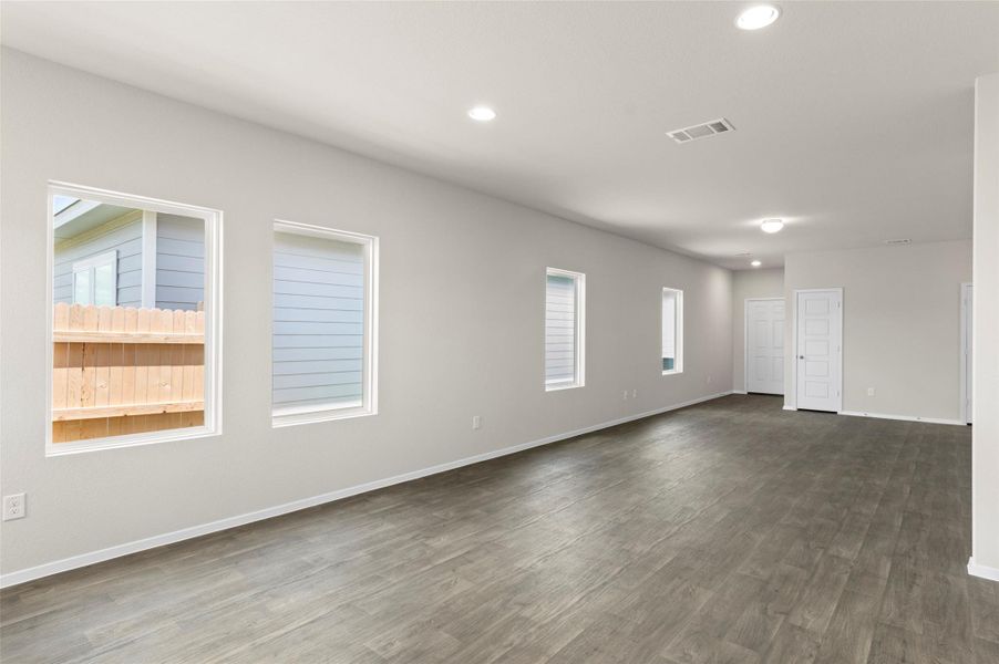 Spare room with dark wood-style flooring and recessed lighting Spare room with dark wood-style flooring and recessed lighting