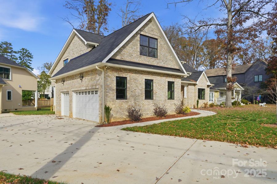 Oversized driveway and two-car garage with carriage-style doors — abundant parking. Oversized driveway and two-car garage with carriage-style doors — abundant parking.