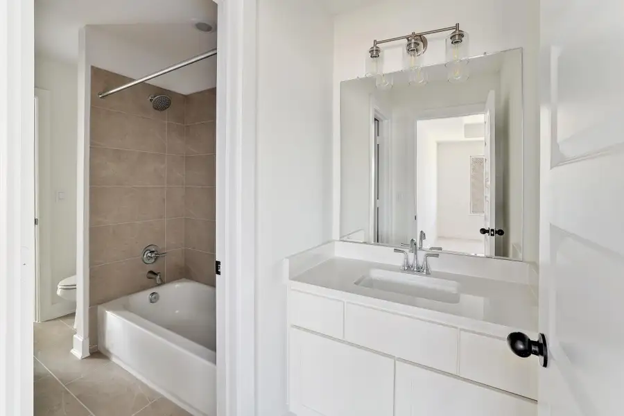 Bathroom with toilet, tile patterned floors, vanity, and shower combination Bathroom with toilet, tile patterned floors, vanity, and shower combination