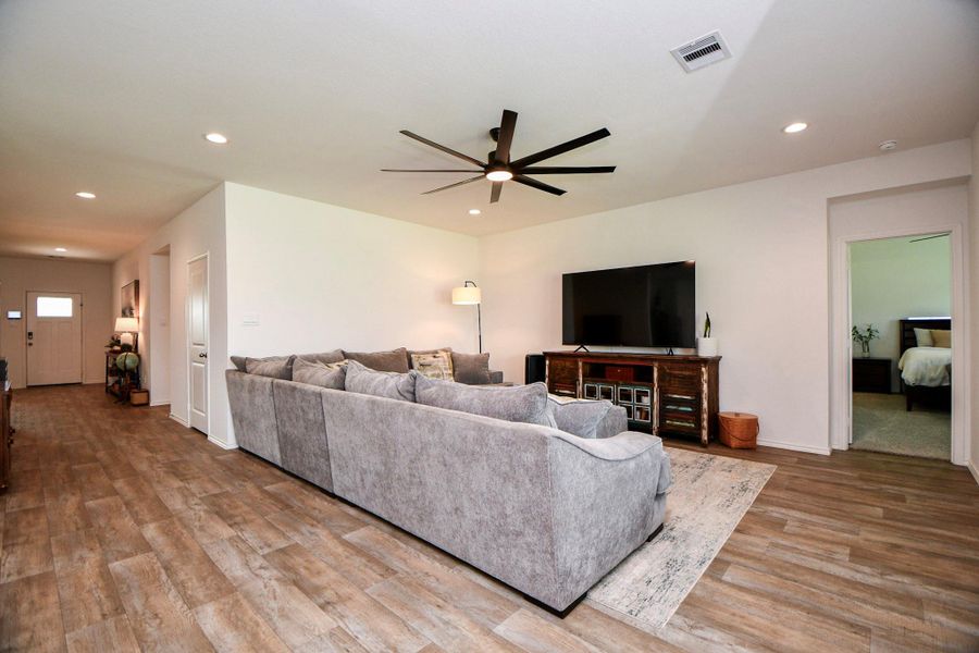 This spacious living room features easy to clean tile flooring, and a modern ceiling fan. This spacious room is perfect to bring your big-screen TV and comfy couch! Time to relax.