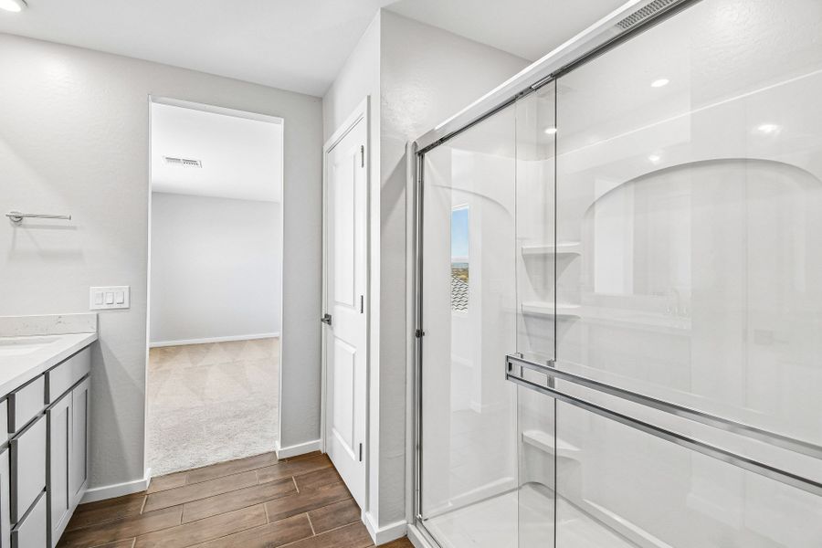 A bathroom with a glass shower. A bathroom with a glass shower.