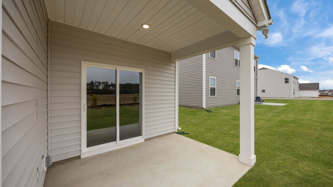 Exterior details and patio area of a home in Ridgewood Farms, Winterville (Image 19).