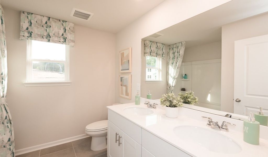 Mornings are a breeze with dual sinks in the upstairs secondary bathroom.