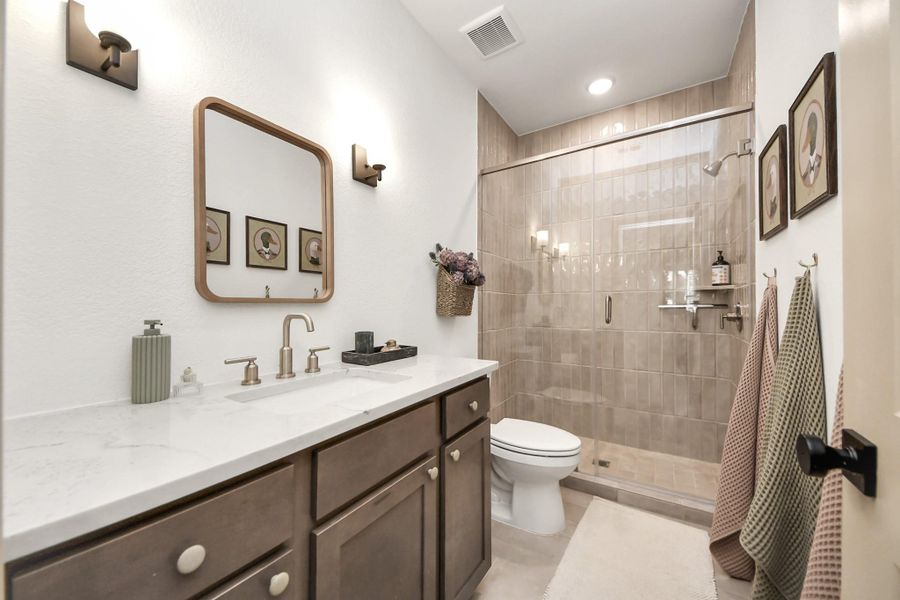 Upstairs bathroom with floor to ceiling tile.