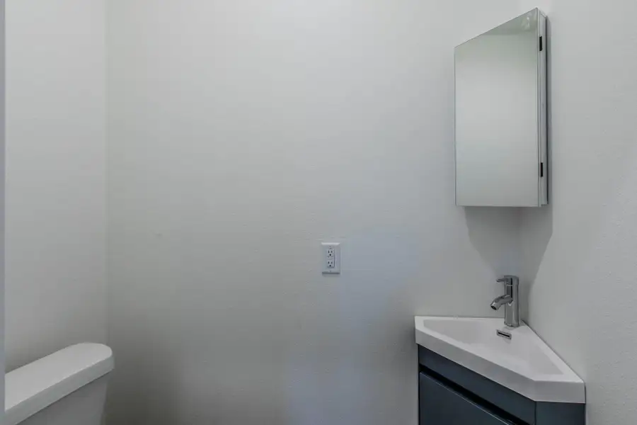 Half bath featuring vanity and toilet