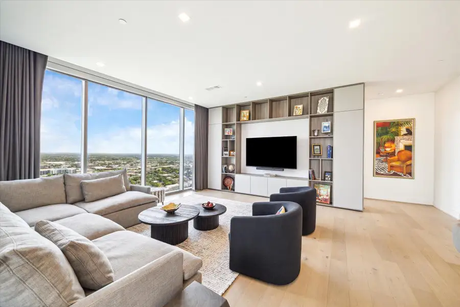 Clean unobstructed views of the city and wonderful ability to display your art with a full wall of built-ins with storage cabinets.